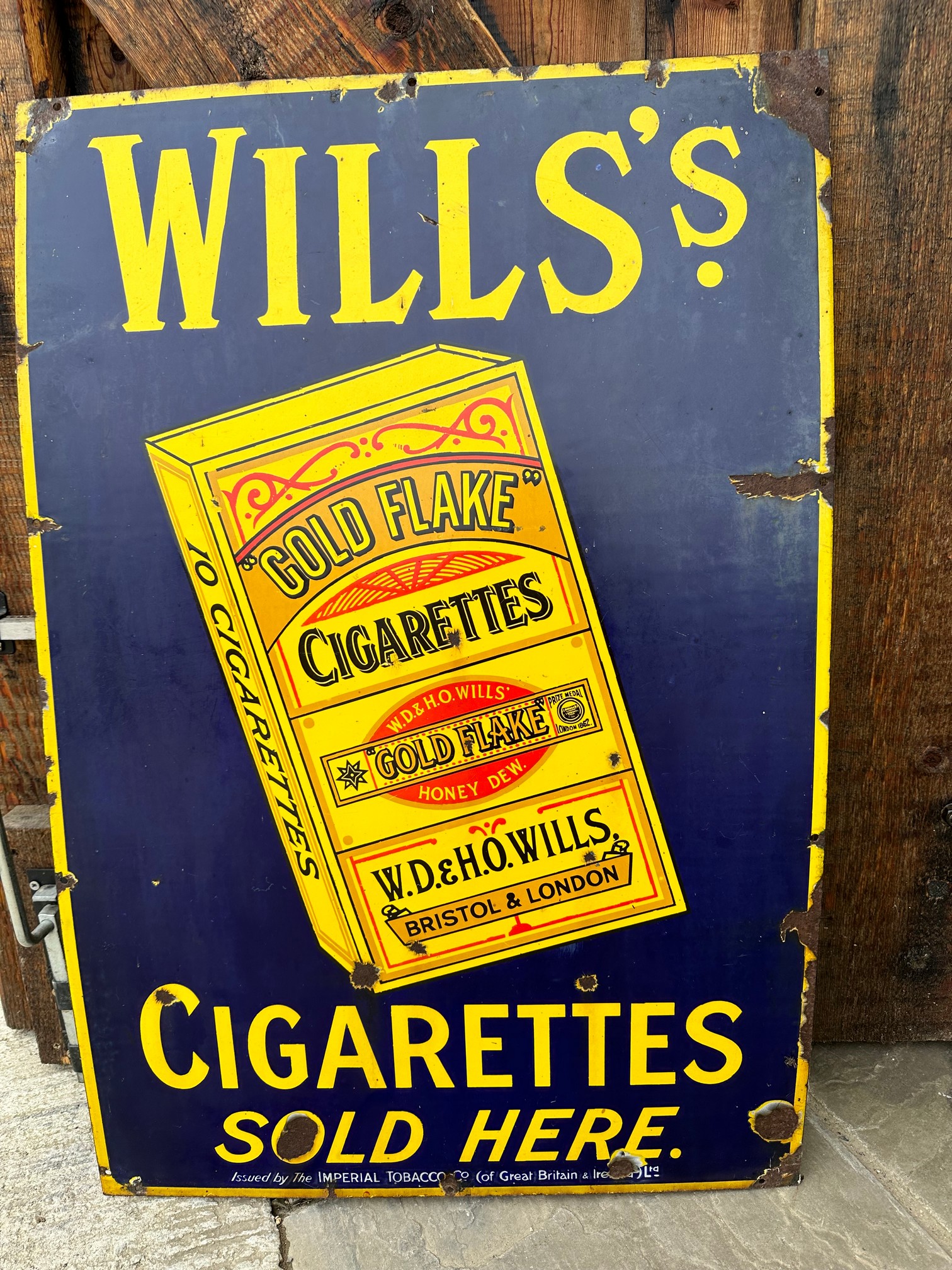 A Wills's Gold Flake Cigarettes Sold Here pictorial 'packet' enamel advertising sign, issued by