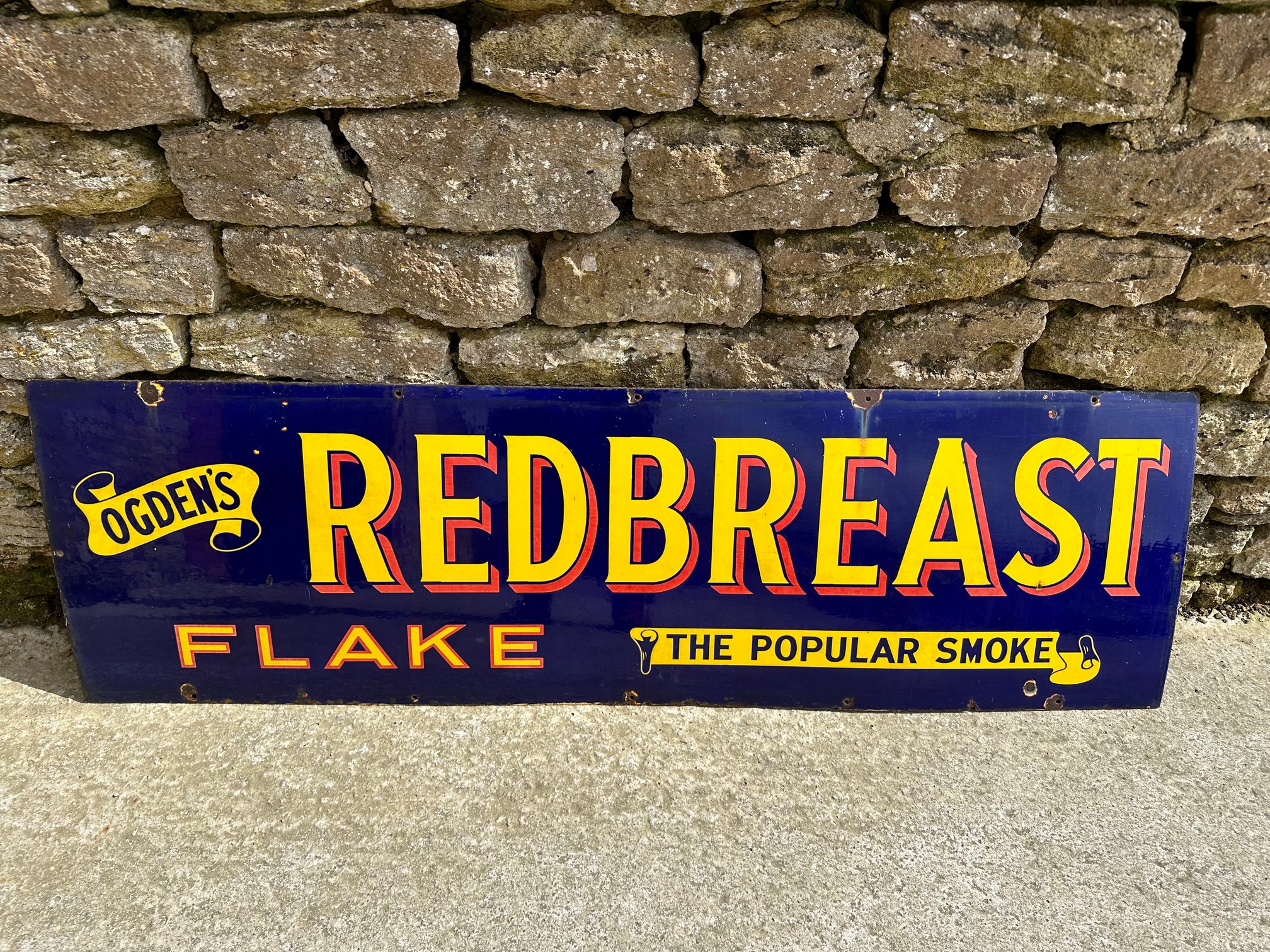 An Ogden's Redbreast Flake "The Popular Smoke" enamel advertising sign, 60 x 18".