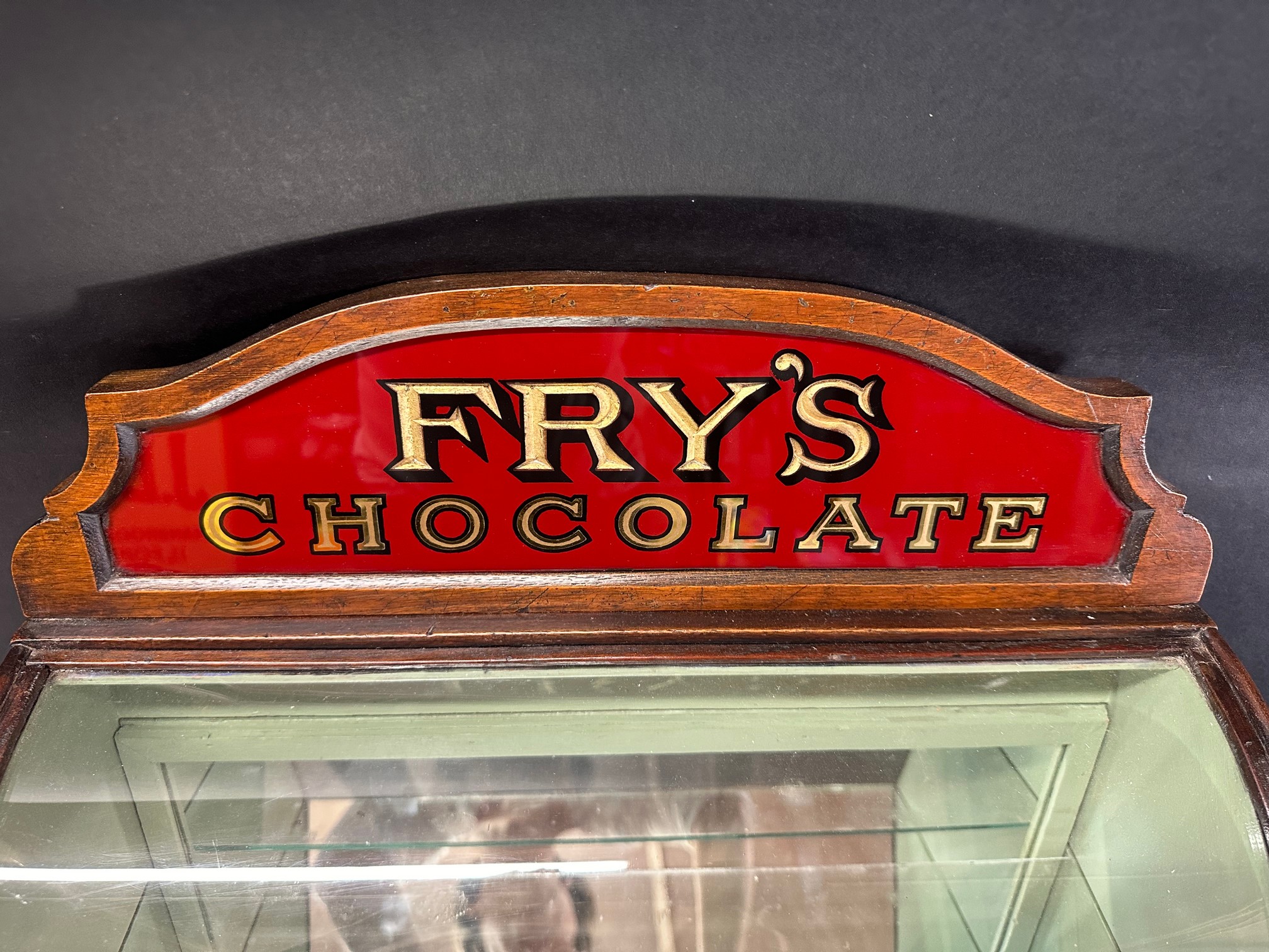 A Fry's Chocolates bowed glass cabinet with pediment, 25 1/2" tall x 9 1/2" deep x 17 3/4" wide. - Image 3 of 7
