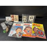 Three 1980s MAD comics, a selection of postcards, a Lincoln Imp, glass model cars etc.