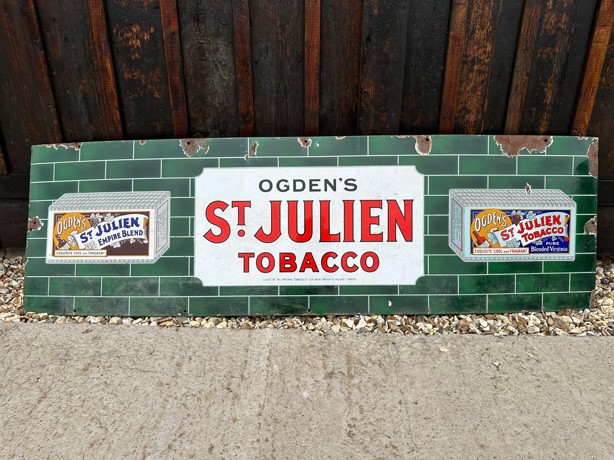 An Ogden's St. Julien Tobacco enamel advertising sign by Imperial Tobacco Co., 60 1/4 x 18".