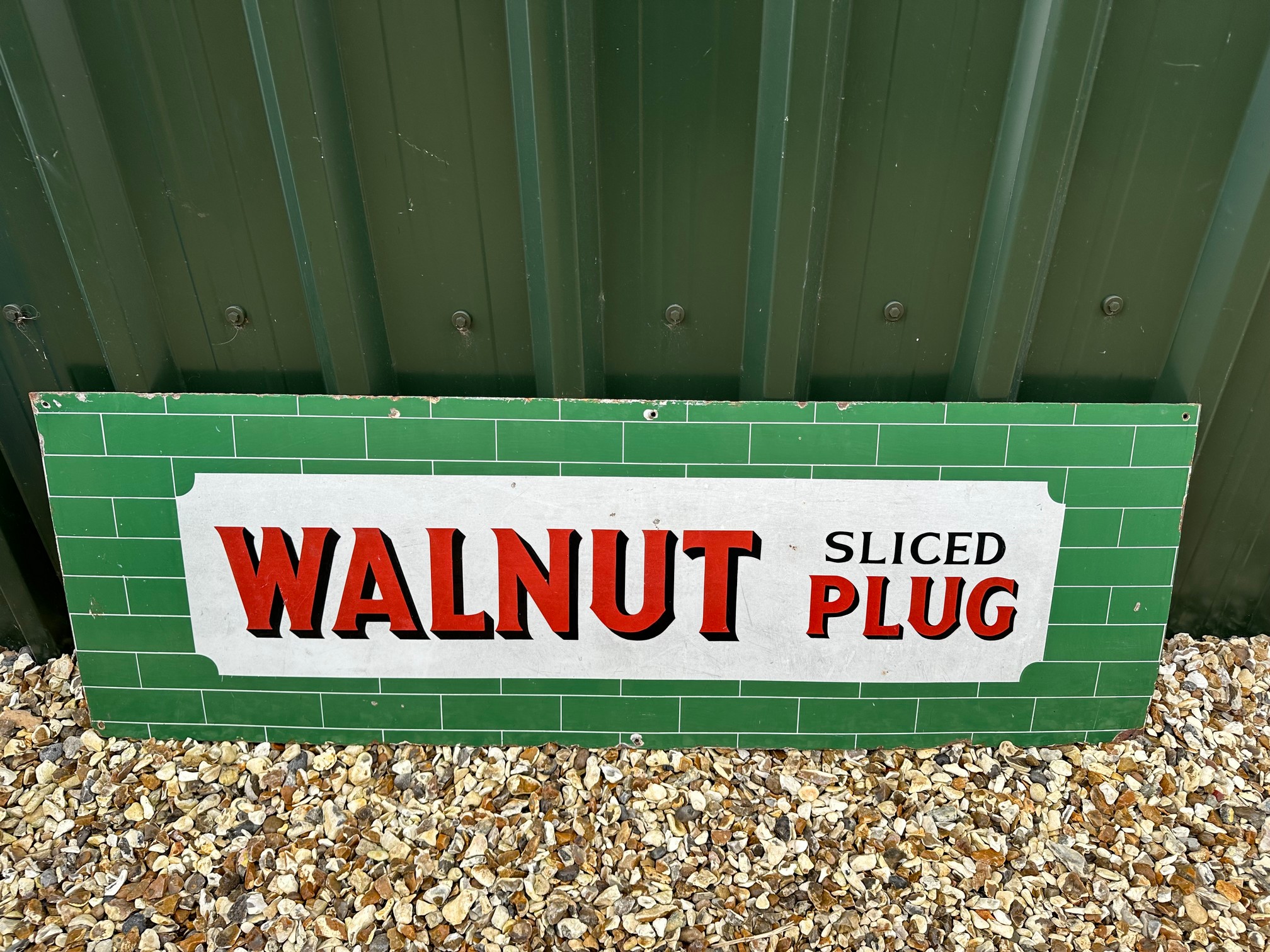 A Walnut Sliced Plug Cigarettes enamel advertising sign, 54 1/4 x 18".