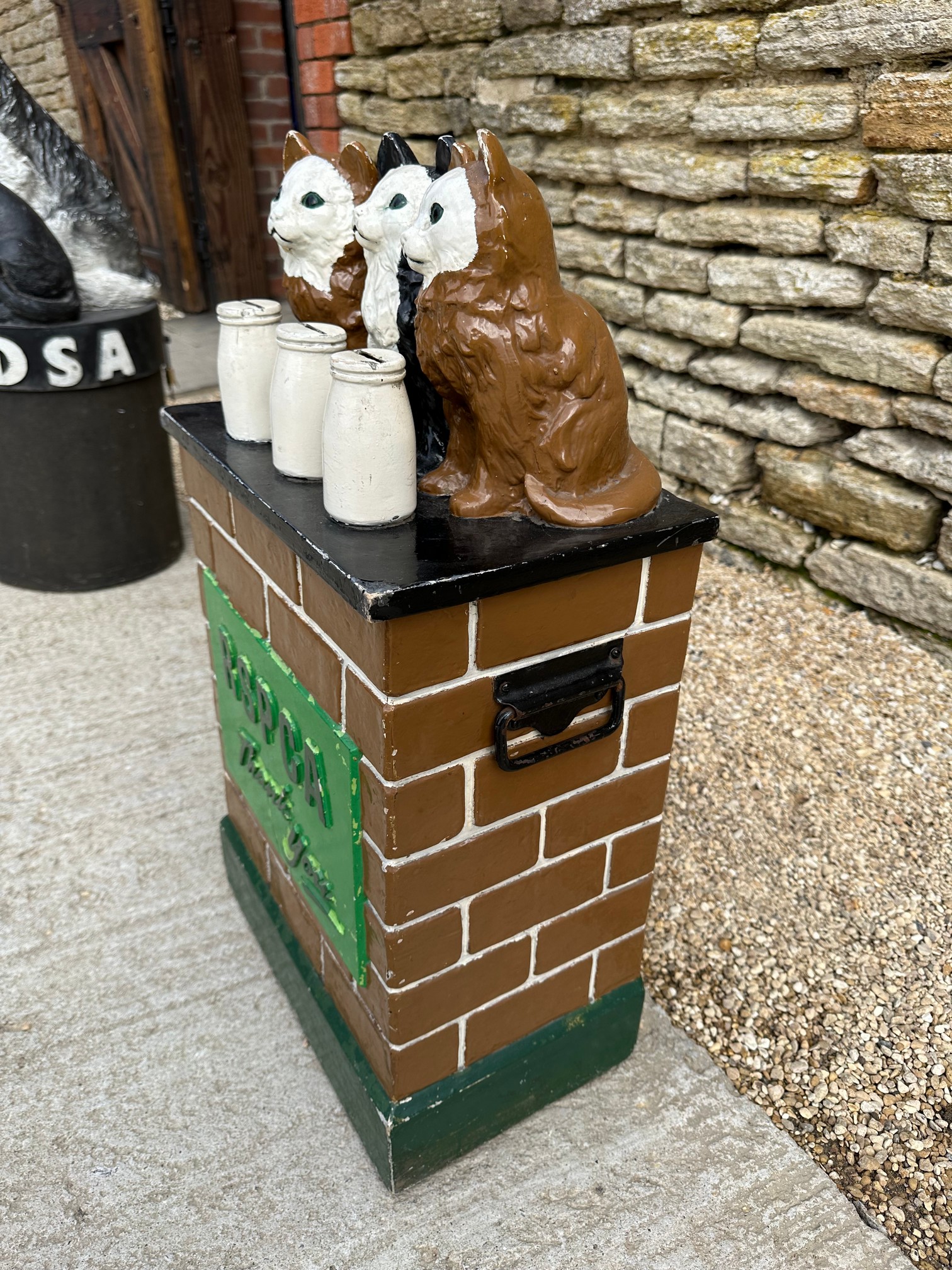 An RSPCA charity donation box with three cats upon a wall behind three milk bottles, with carry - Image 2 of 5