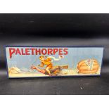 A Palethorpes Sausages advertisement depicting a snow scene of a boy riding a turkey pulling a