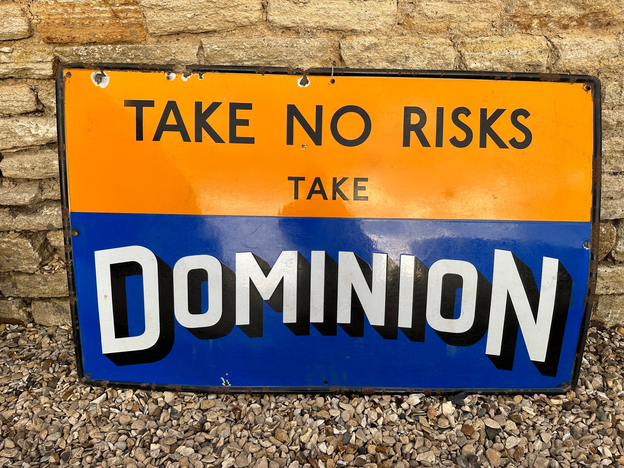 A Dominion "Take No Risks" single sided enamel adverting sign of good colour, 48 x 31".