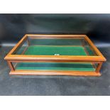 A counter top display case with rising lid and felt base, 25 3/4 x 17 1/4 x 6 1/4".