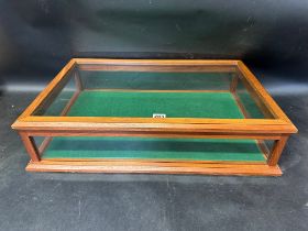 A counter top display case with rising lid and felt base, 25 3/4 x 17 1/4 x 6 1/4".