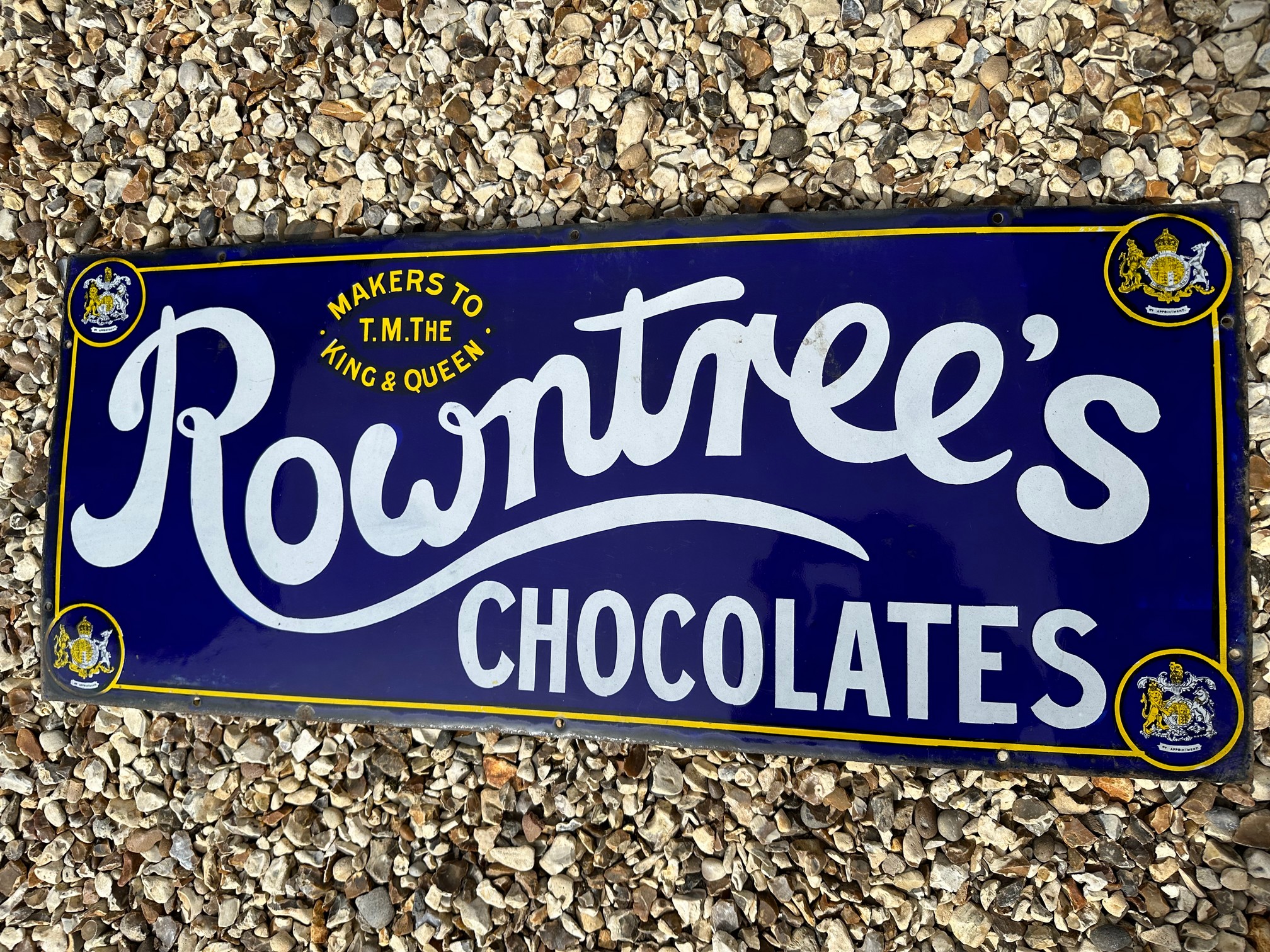 A Rowntree Chocolates enamel advertising sign, 'Makers to T.M. The King & Queen, 36 x 15".