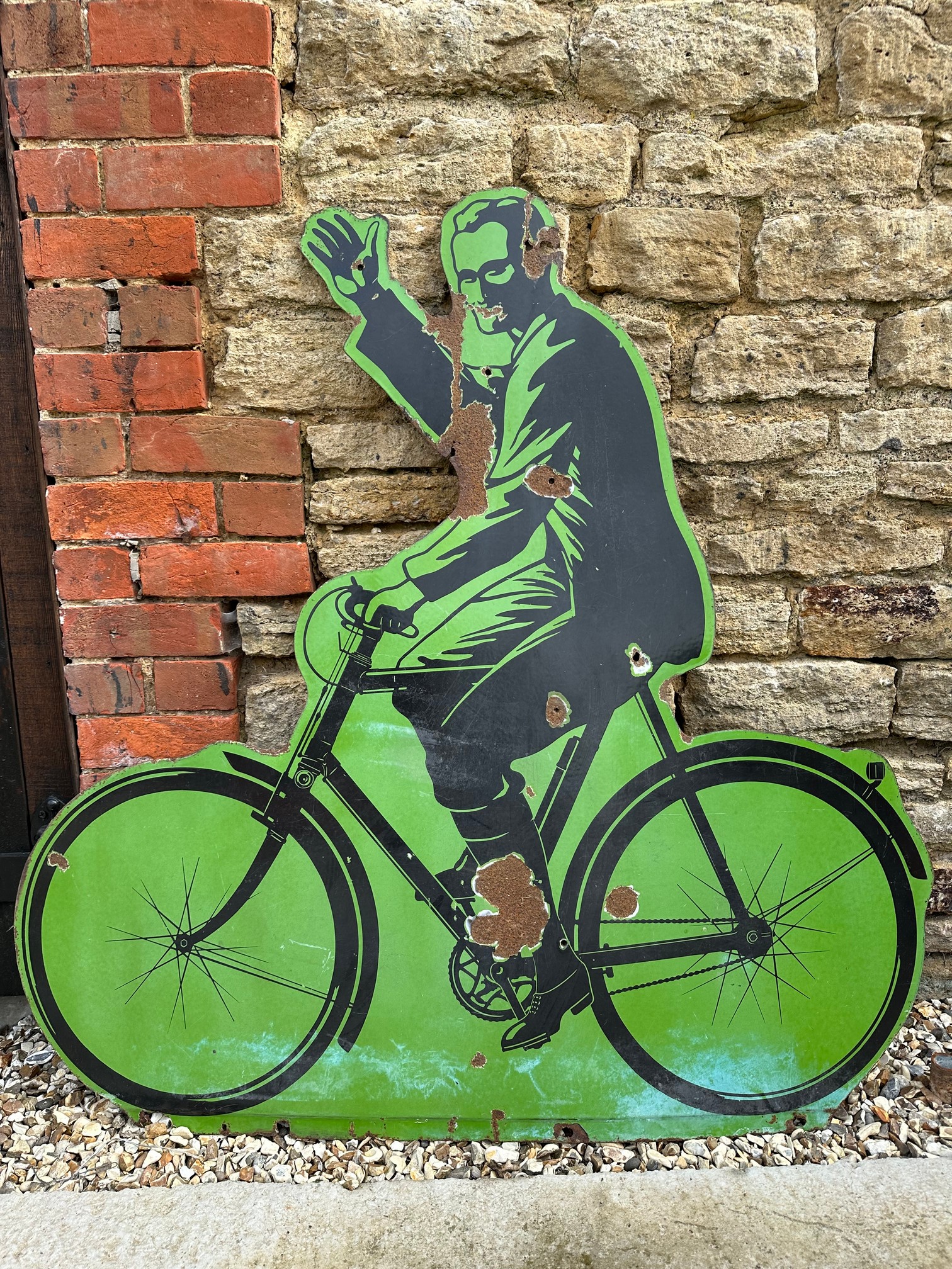 A large Raleigh gentleman on bicycle enamel sign, 48 x 47 3/4".