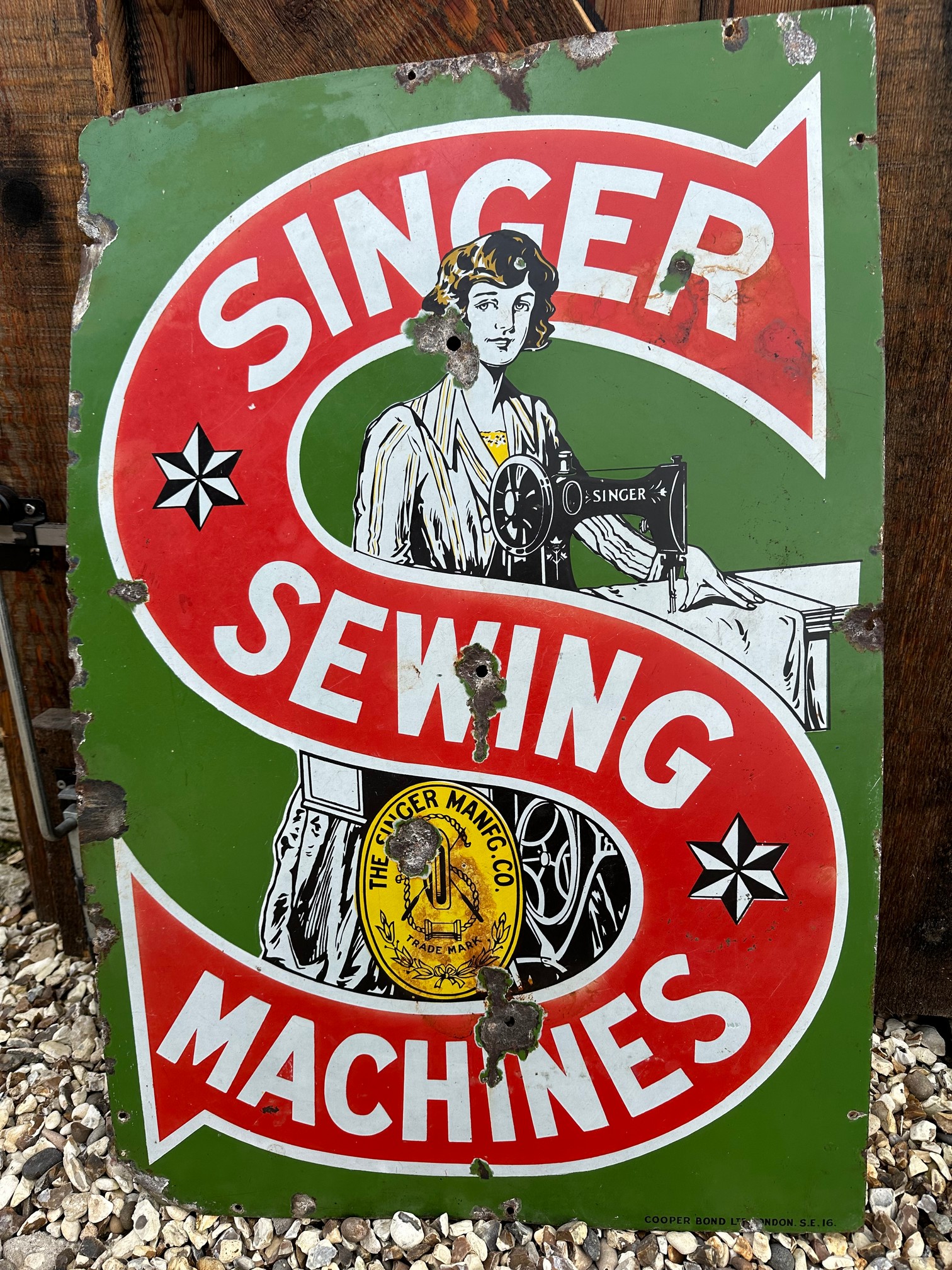 A Singer Sewing Machines enamel advertising sign by Cooper Bond Ltd. London SE16, 24 x 36".