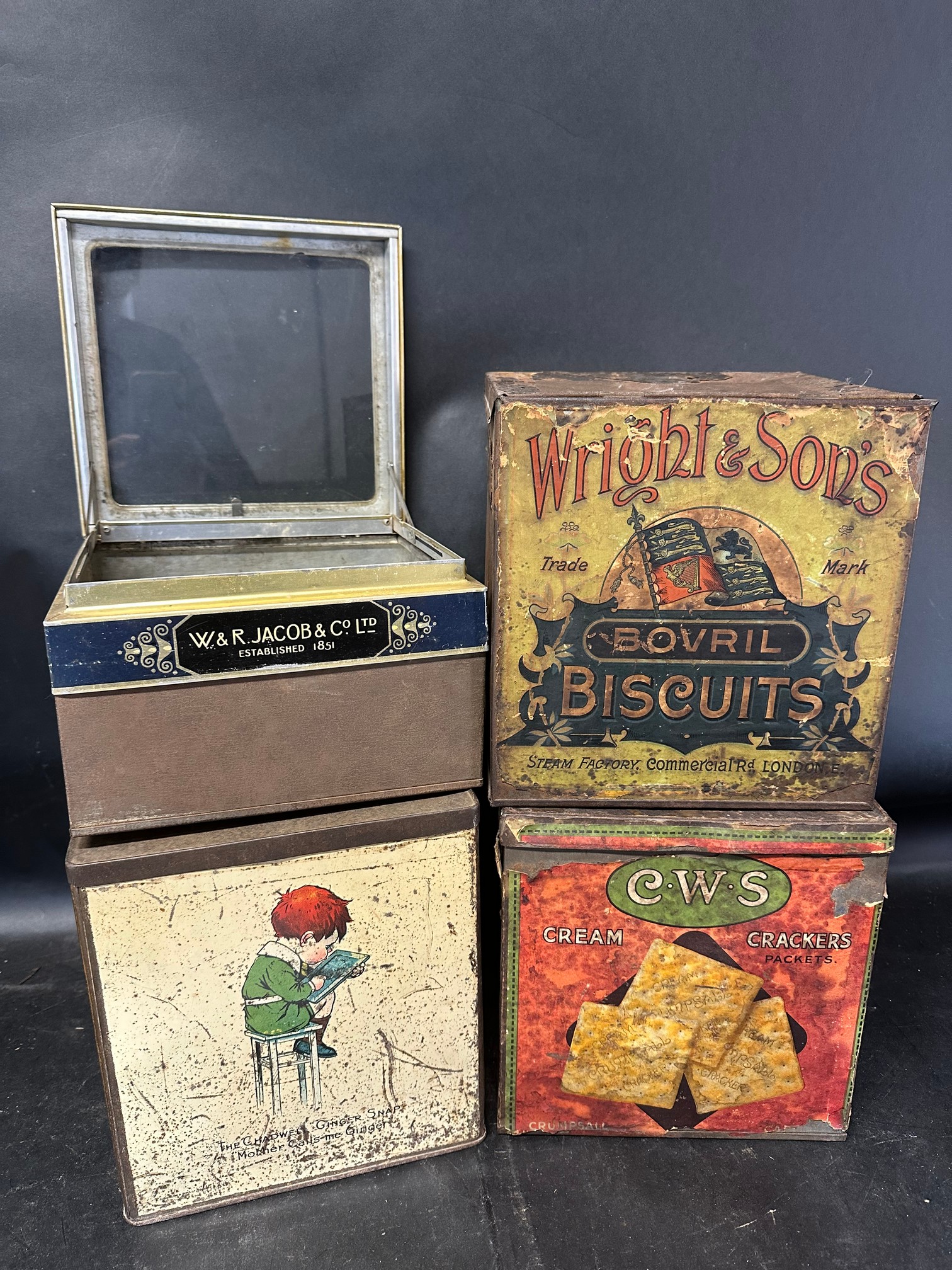 Four shop counter top dispensing tins: Wright & Son's Bovril Biscuits, C.W.S. Biscuits, W & R
