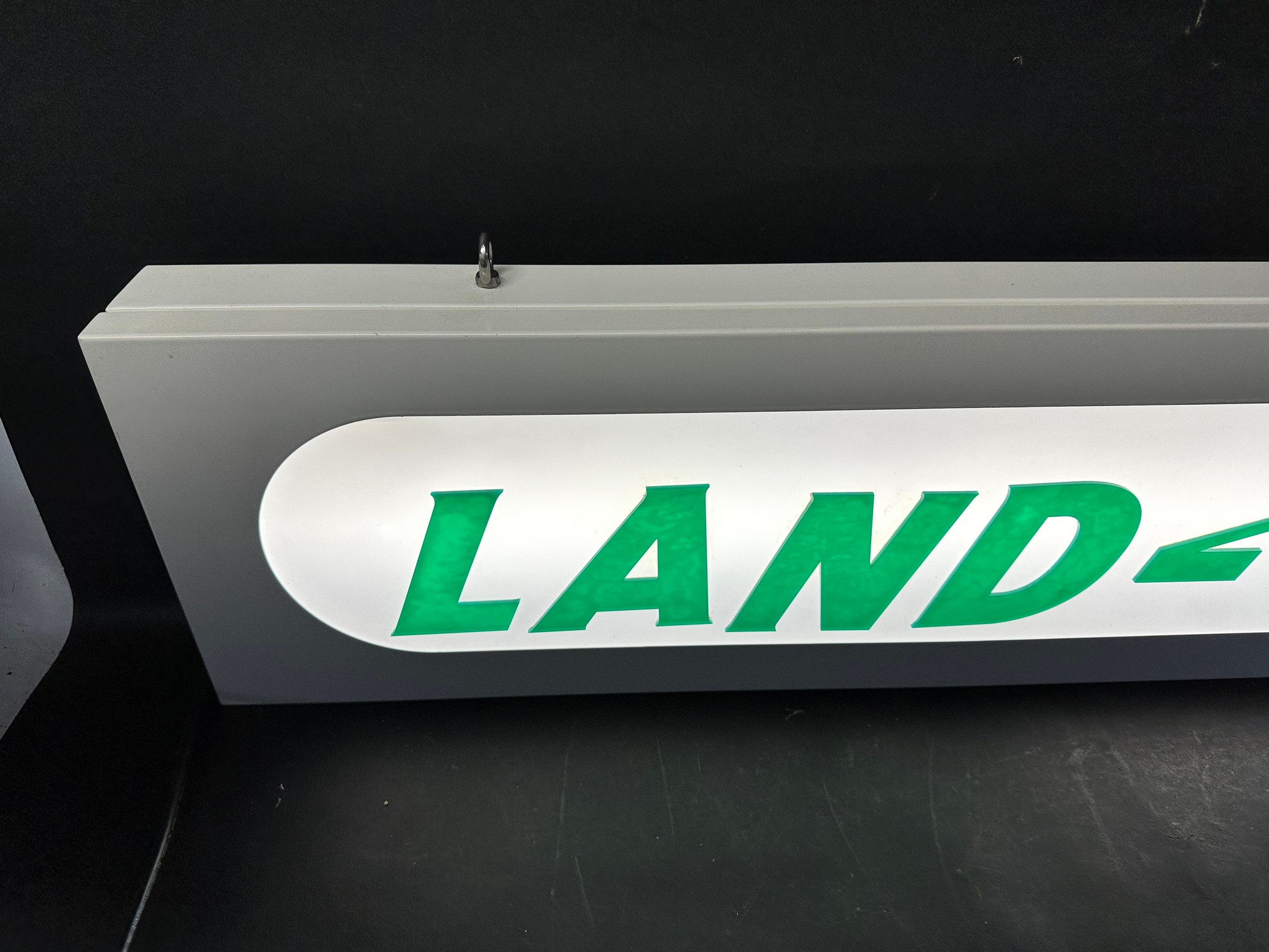 A hanging lightbox with Land Rover applied in acrylic letters, 47 1/4 x 9 x 2 3/4". - Image 2 of 5