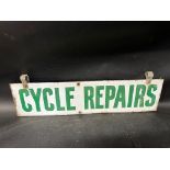 A Cycle Repairs hanging enamel advertising sign, 24 1/4" wide, 6" high excluding attachments, 7 1/4"