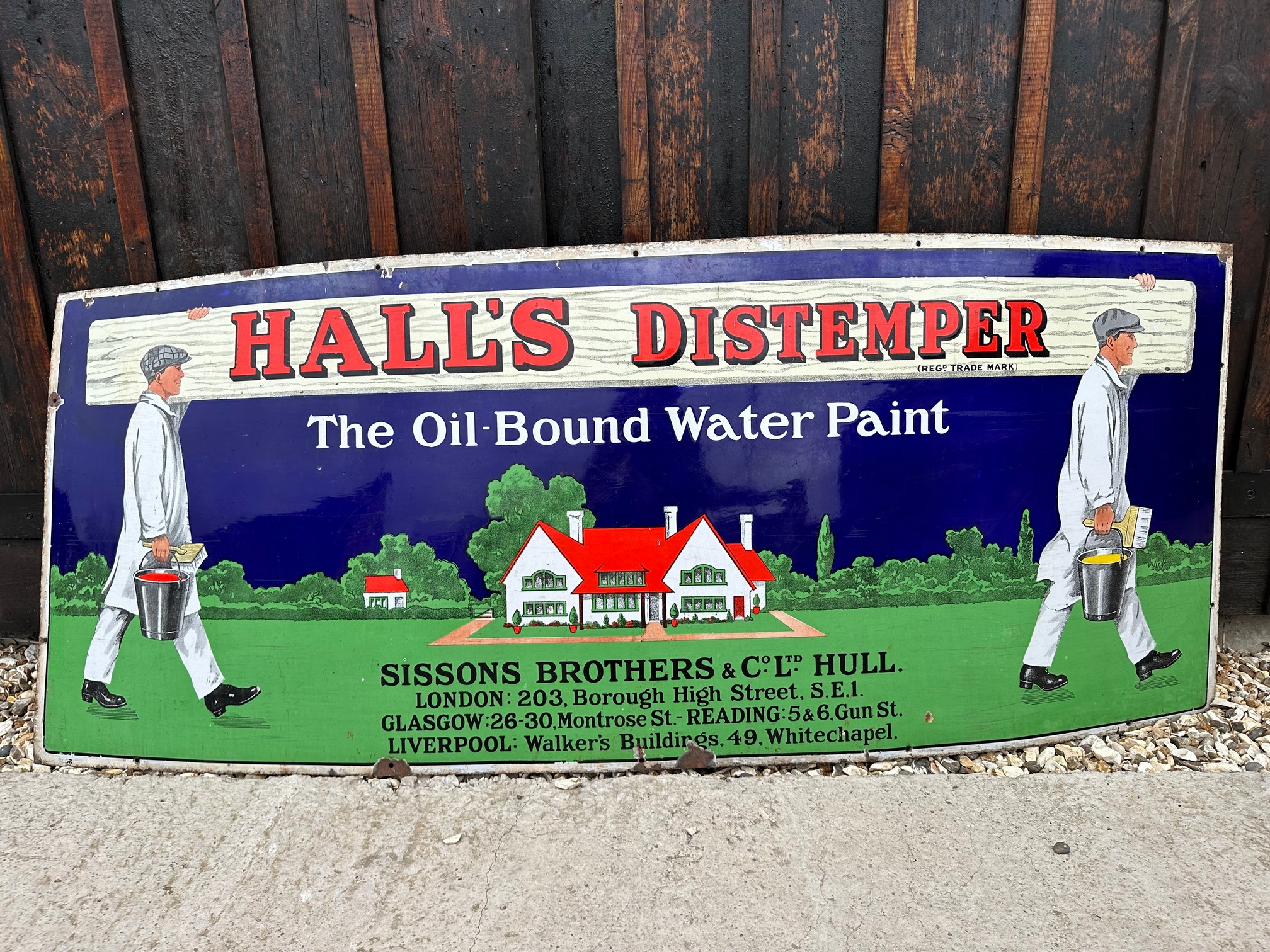 A Hall's Distemper enamel advertising sign depicting two decorators carrying paint and a plank, by