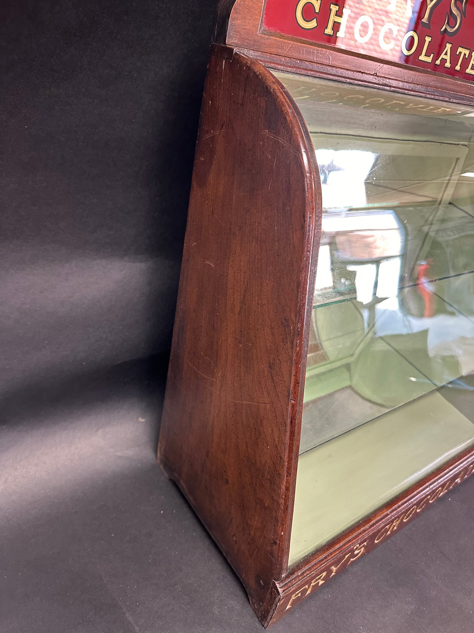 A Fry's Chocolates bowed glass cabinet with pediment, 25 1/2" tall x 9 1/2" deep x 17 3/4" wide. - Image 4 of 7