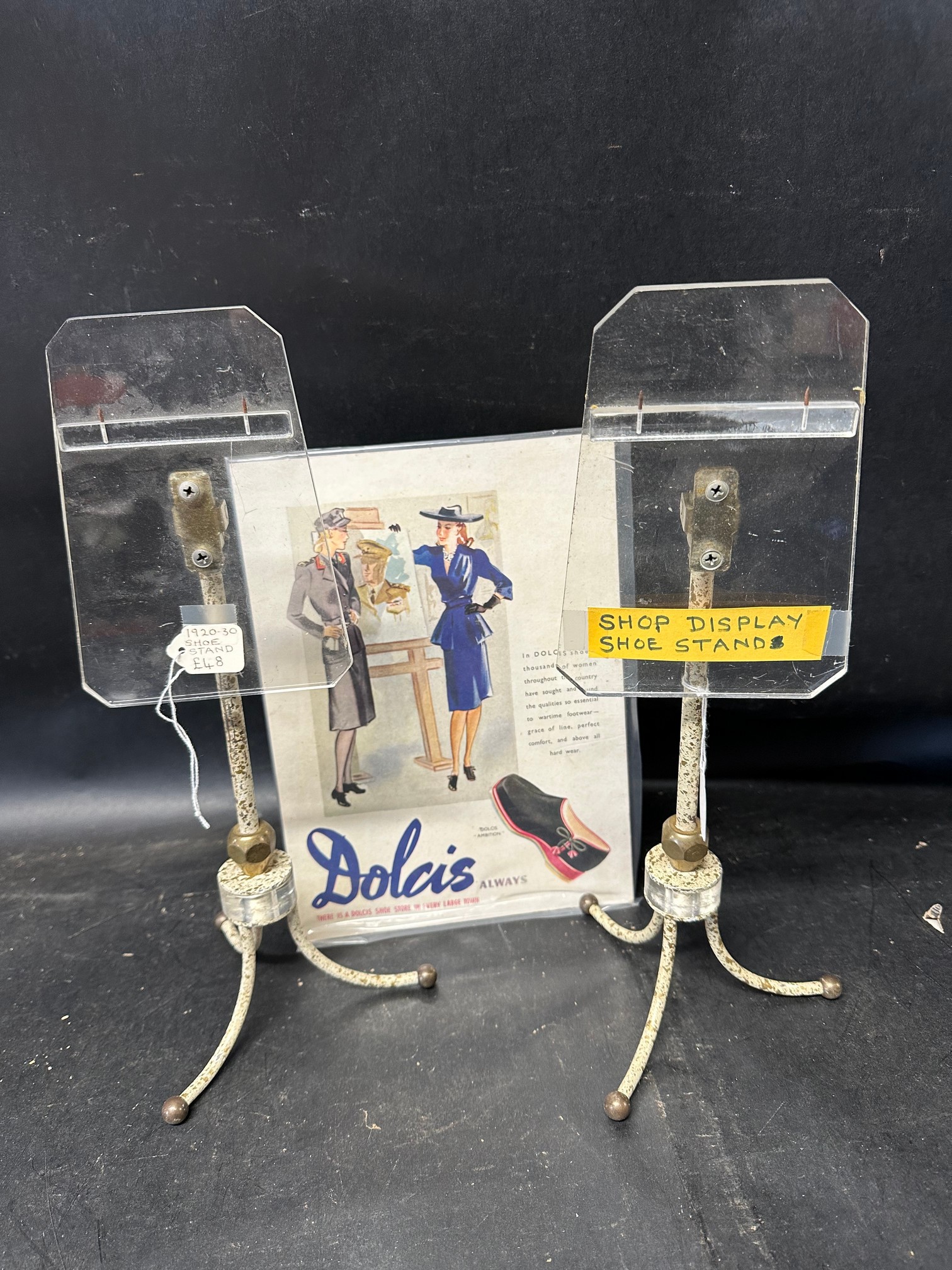 Two 1920s/30s shoe stands and a Dolcis Shoes showcard.