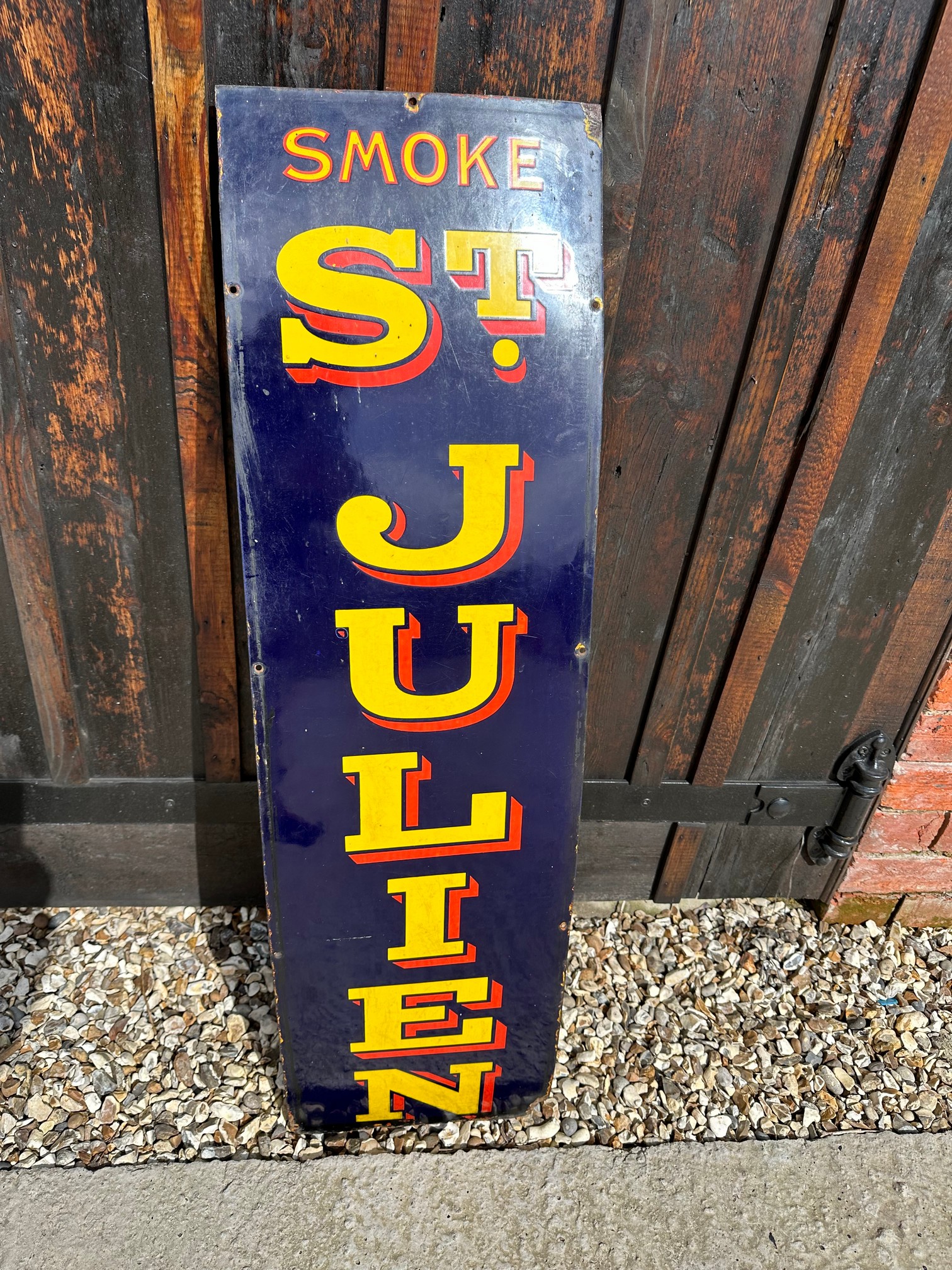 A Smoke St. Julien enamel advertising sign, 12 x 43".