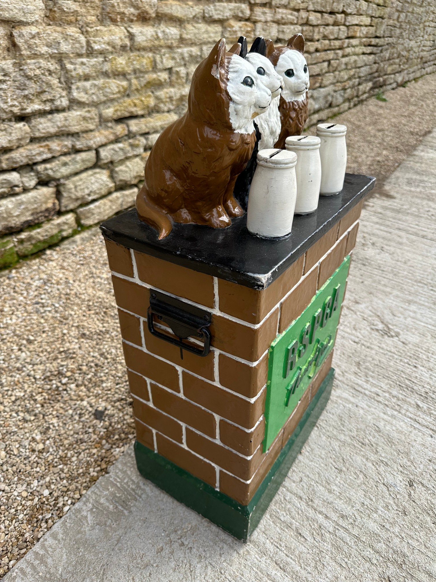 An RSPCA charity donation box with three cats upon a wall behind three milk bottles, with carry - Image 3 of 5