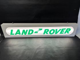 A hanging lightbox with Land Rover applied in acrylic letters, 47 1/4 x 9 x 2 3/4".