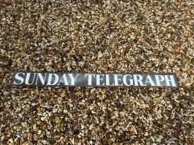 A Sunday Telegraph enamel advertising sign, 42 x 4".