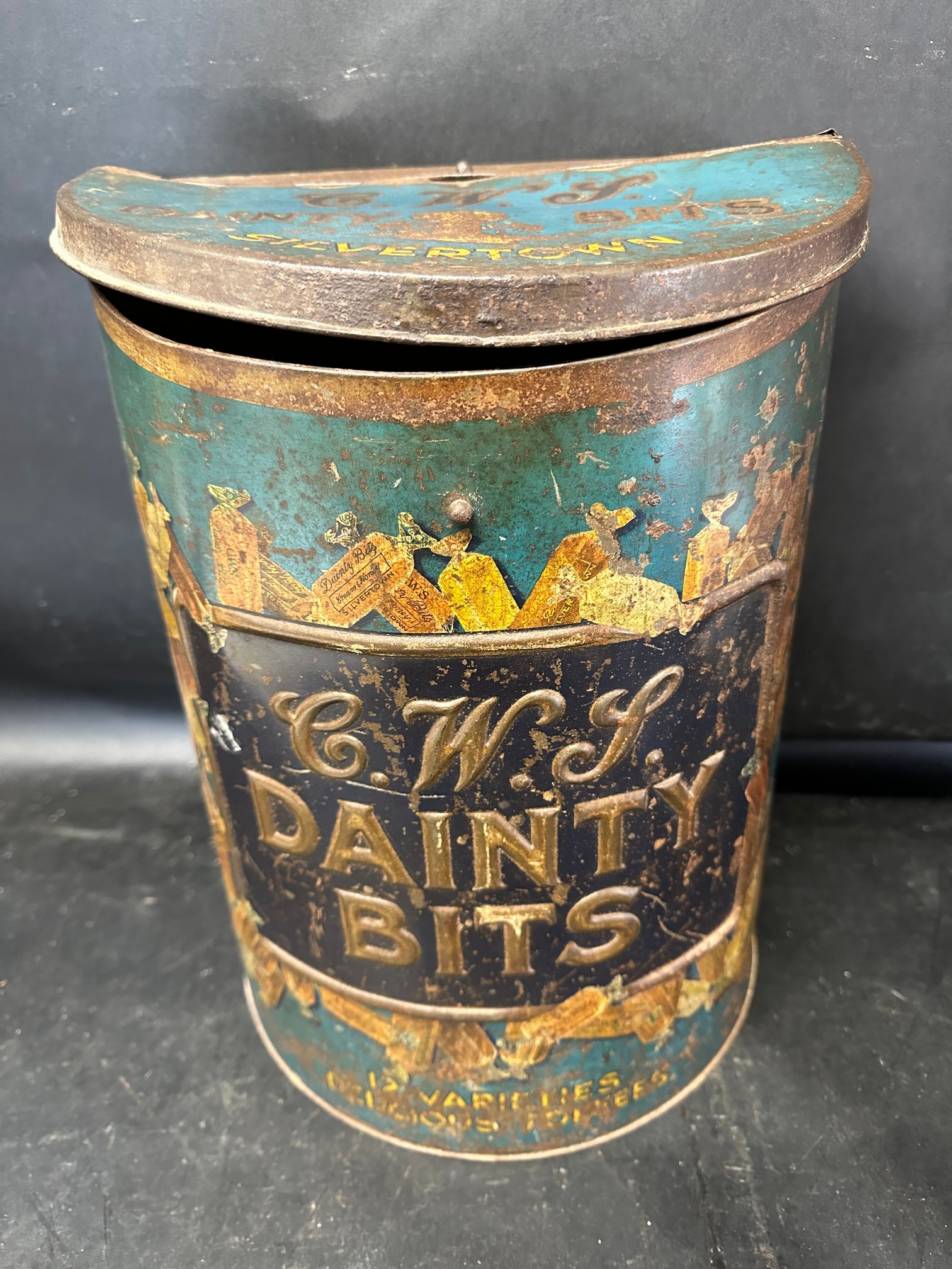 A C.W.S. Dainty Bits large counter top display dispensing advertising toffee tin, 14 1/2" tall.