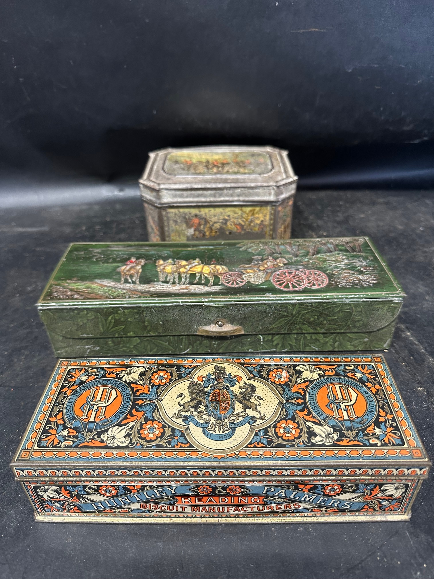Three Huntley & Palmer's Ltd. confectionery tins including hunting scenes, horse and carts etc.