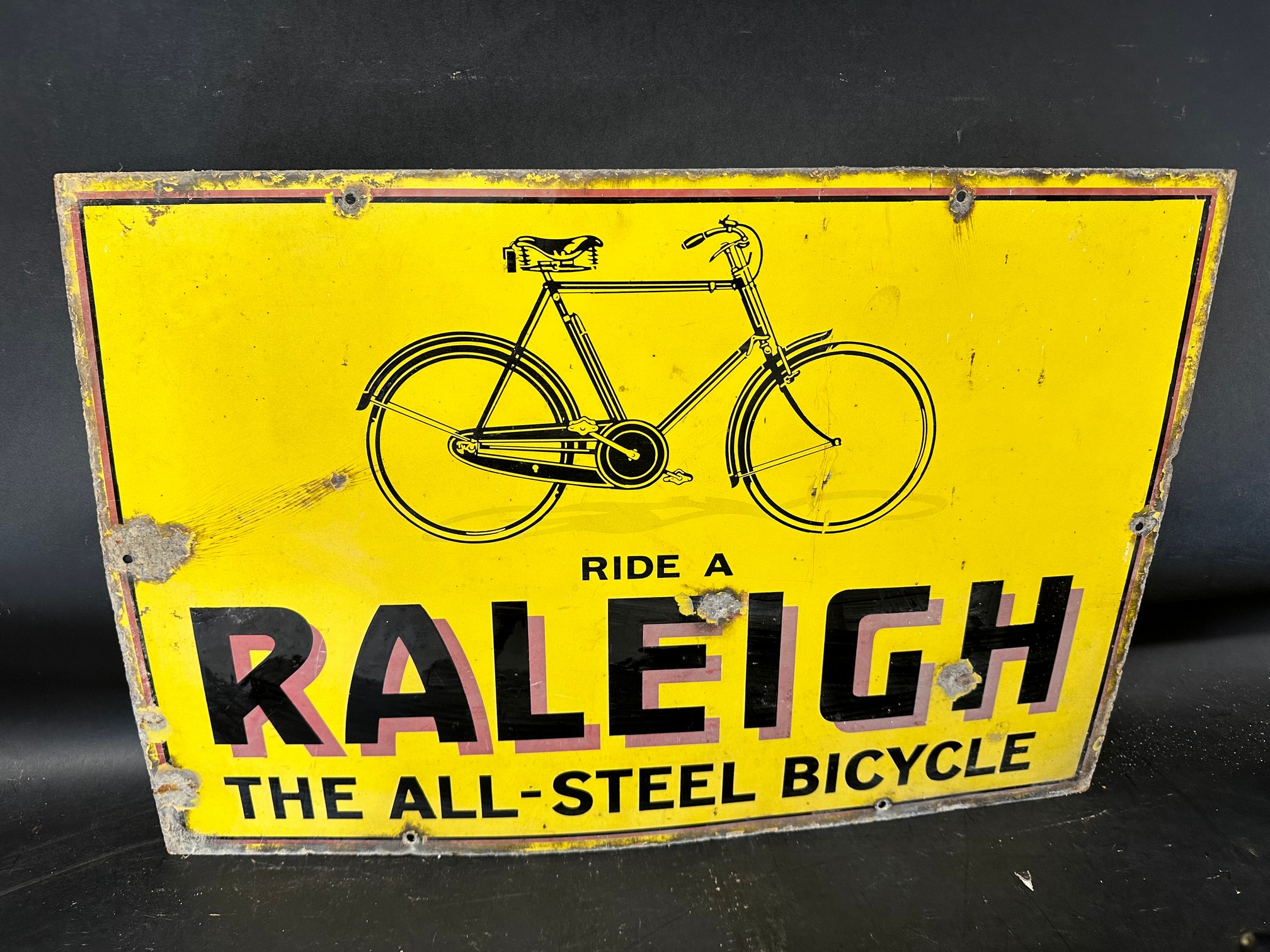 A Raleigh enamel advertising sign with illustration of bicycle, 'Ride a Raleigh the All-Steel