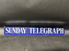 A Sunday Telegraph enamel advertising sign, 22 1/2 x 3 1/2".