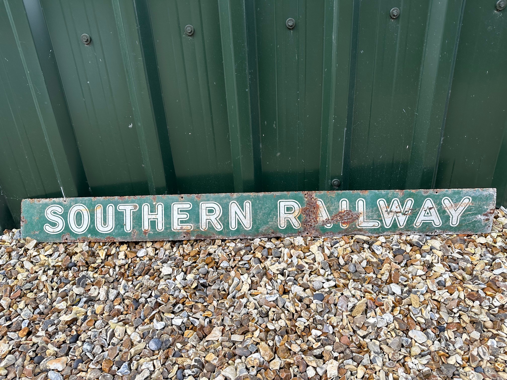 A Southern Railway enamel advertising sign, 52 x 5" by repute from Basingstoke Station.