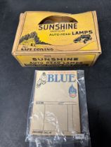 A box of Sunshine gas-filled Auto Head Lamps, new old stock and an Esso Blue invoice pad.