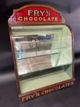 A Fry's Chocolates bowed glass cabinet with pediment, 25 1/2" tall x 9 1/2" deep x 17 3/4" wide.