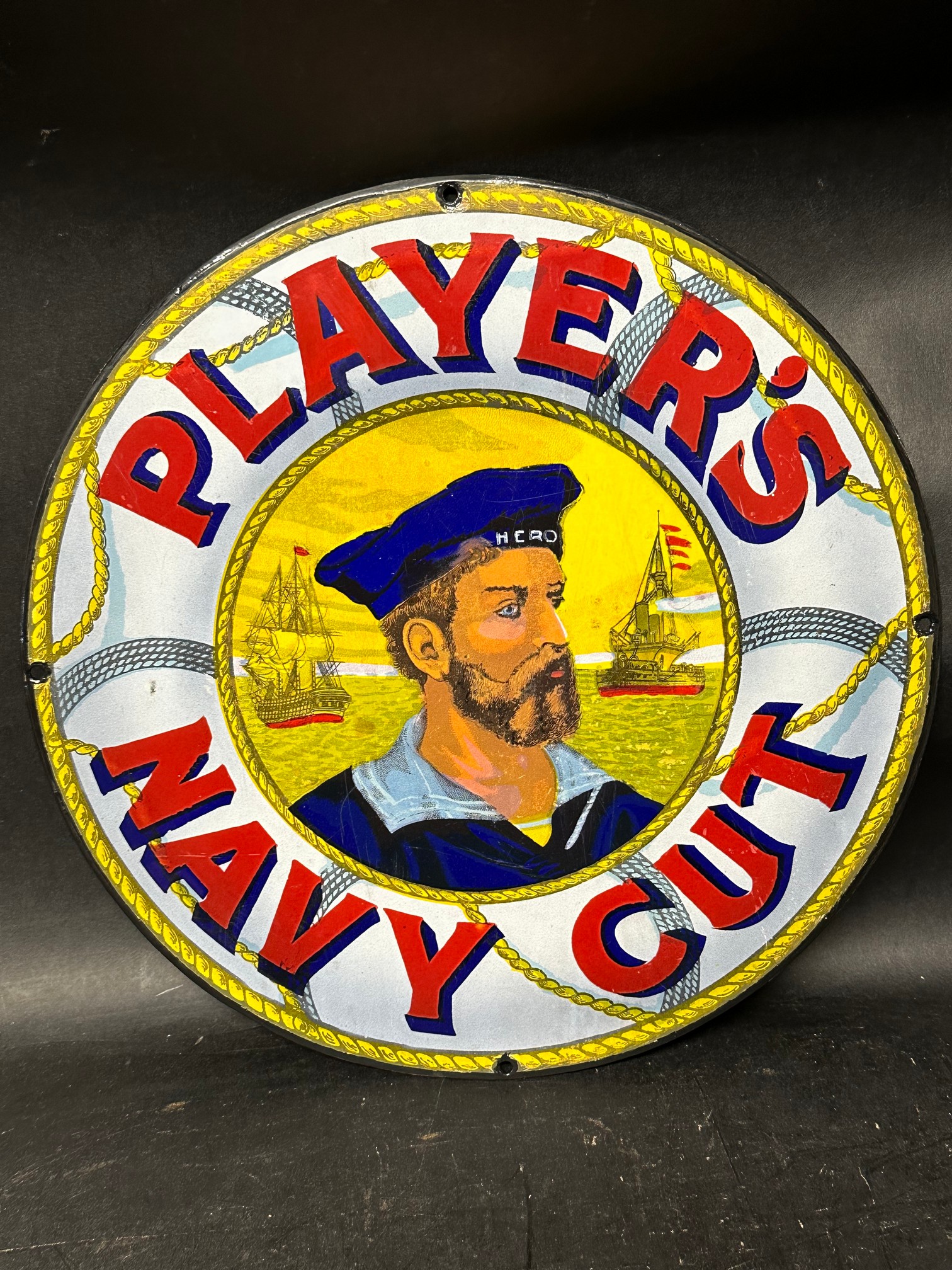 A Player's Navy Cut circular enamel advertising sign (cut out from a larger sign), 12 1/4" diameter.