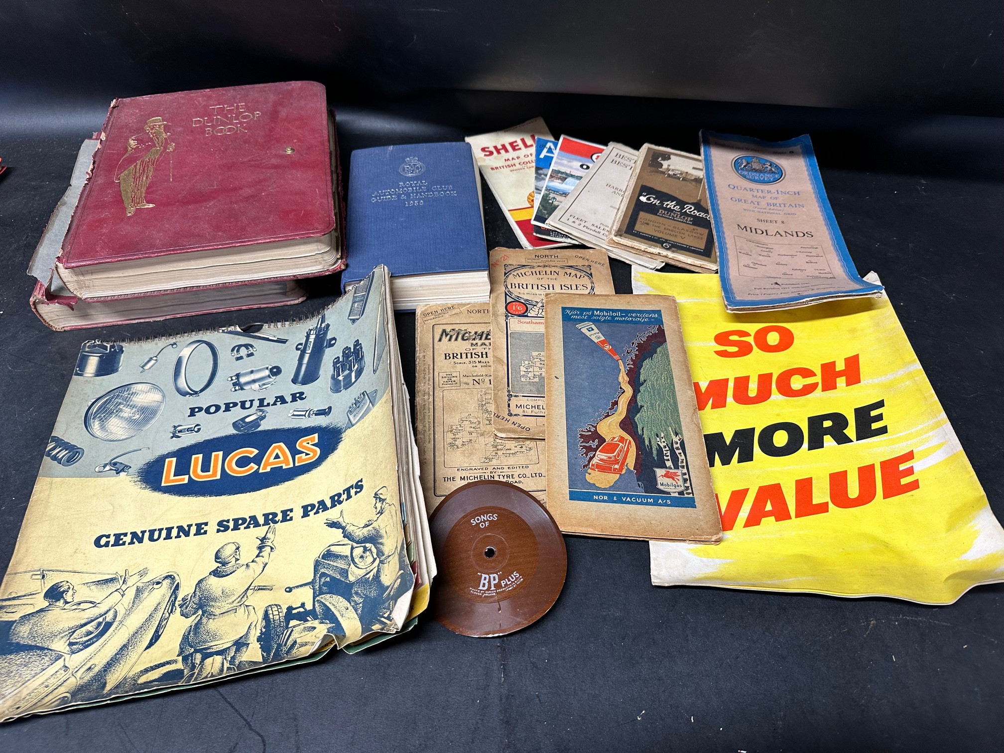 Two editions of The Dunlop Book, a 1958 RAC Guide and Handbook, a Lucas parts hanging chart, various