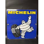 A Michelin single sided enamel sign depicting Mr Bibendum rolling a tyre made in France 1982, 25 3/