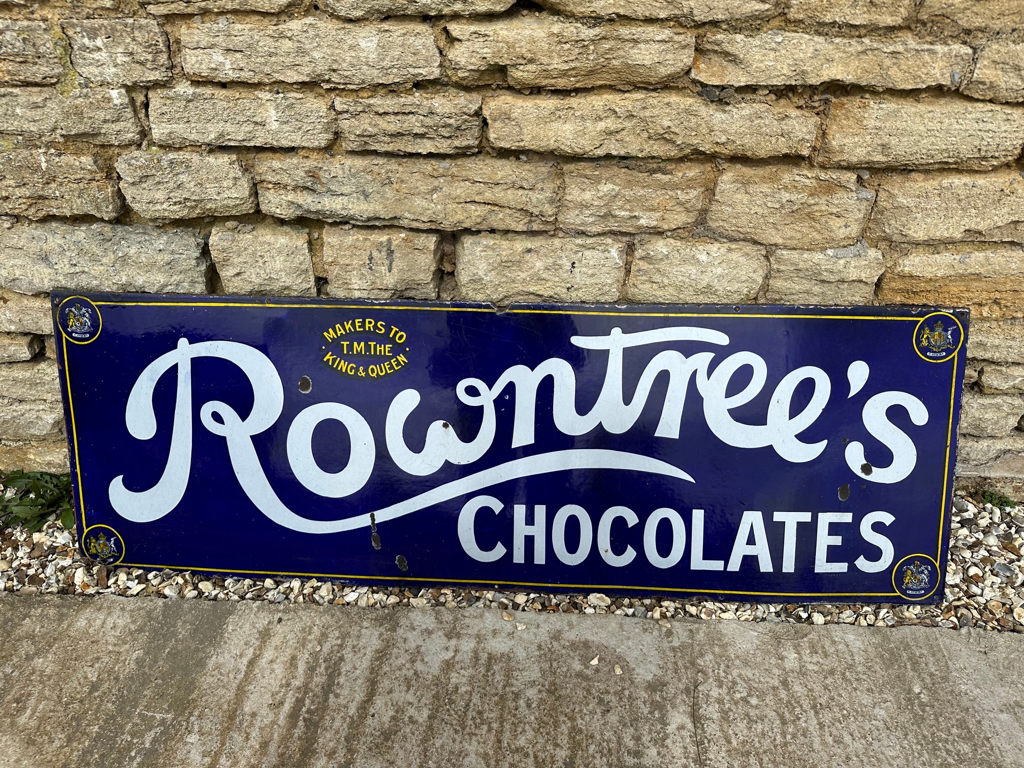 A Rowntree's Chocolates enamel advertising sign with Royal Warrants for "The King and Queen", 60 1/4