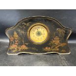 A shaped tole clock confectionery tin circa 1910 depicting Oriental scenes, possibly by Champion
