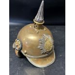 A salesman's sample of a pickelhaube brass helmet, 6" high, 6" long and 4 1/4" wide.