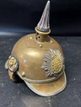 A salesman's sample of a pickelhaube brass helmet, 6" high, 6" long and 4 1/4" wide.