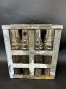 An eight-division oil crate containing seven Essolube and one Esso quart oil bottles.