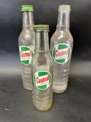 Three Castrol glass motor oil bottles, two with caps - two quarts and a pint.