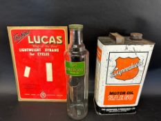 A BP Energol quart bottle with cap, a Lucas Cycles showcard and a Super Shield Motor Oil 9lb can.