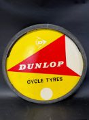 A Dunlop Cycle Tyres hardboard advertising tyre insert in a rubber tyre, 26 1/4 x 32 1/4