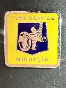 A Michelin Tyre Service enamel badge.