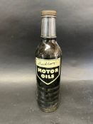 A Duckhams quart glass oil bottle with lid.