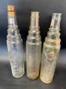 Three glass quart oil bottles: 2 x Essolube and an Esso.