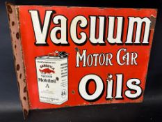 A Vacuum Motor Car Oils pictorial double sided enamel advertising sign with hanging flange with