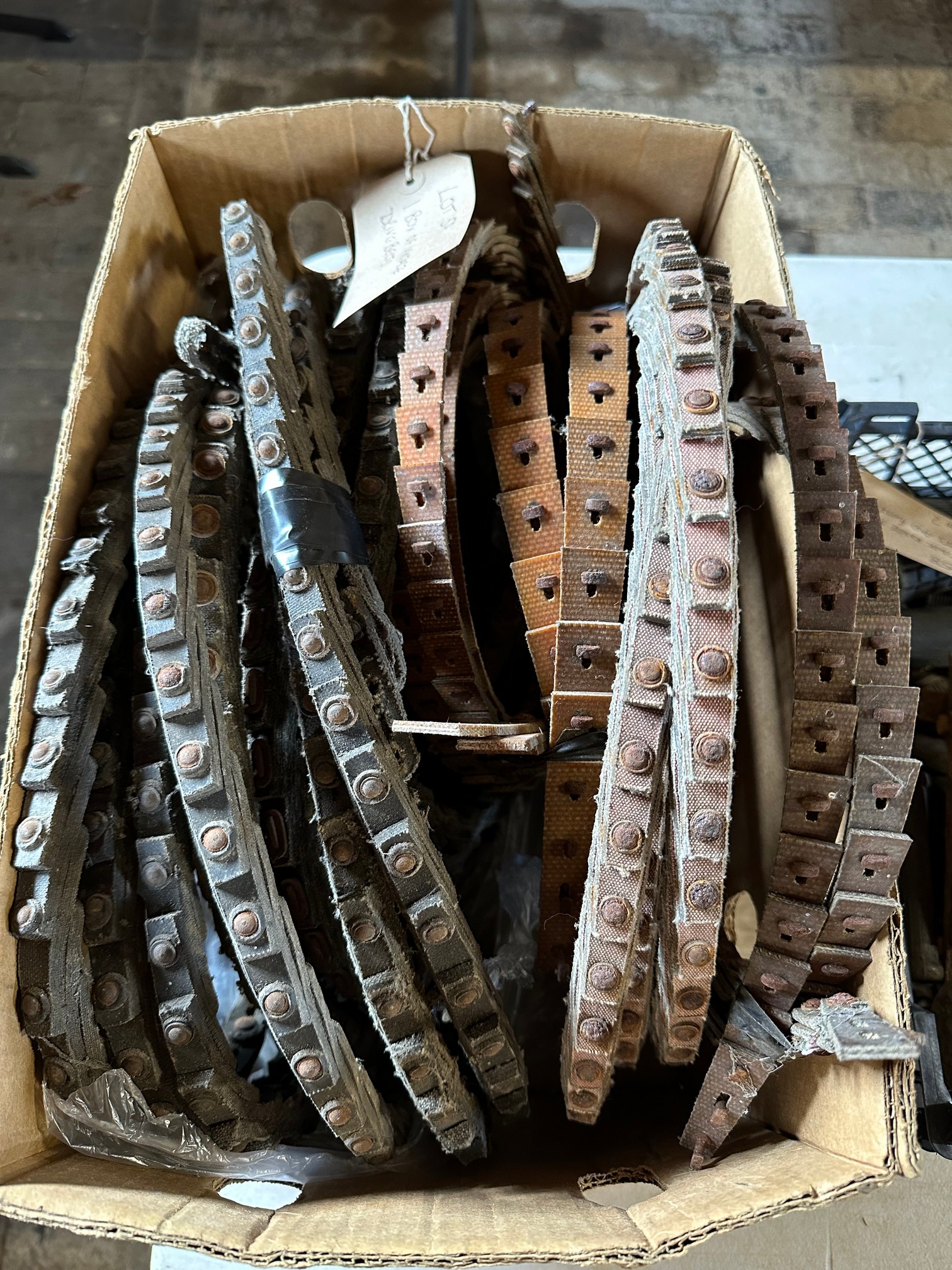A box of vintage drive 'V' belts.
