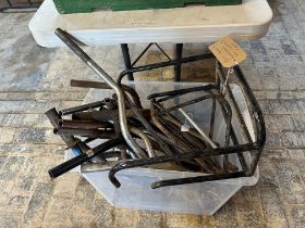 A luggage rack and selection of mixed handlebars.