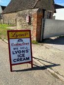 A Lyons' Ice Cream enamel advertising sign in wooden freestanding frame, 23 3/4 x 41 3/4