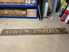 Two parts of a wooden hand painted Welsh advertising sign 'Owen Parry', 48 x 10 1/2